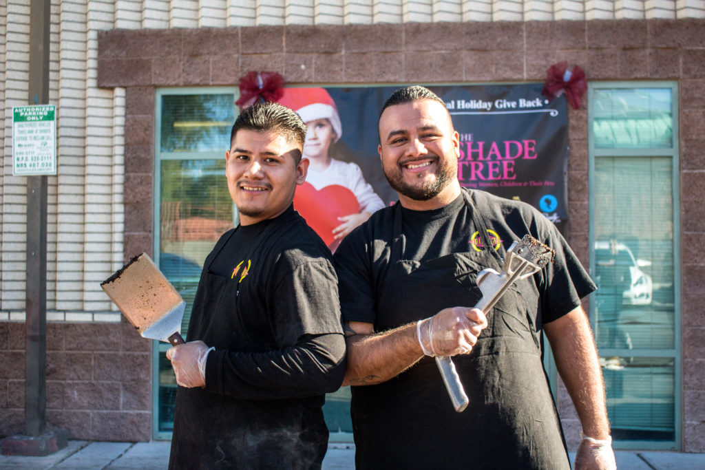 Fatburger employees posing for photo at The Shade Tree holiday event.