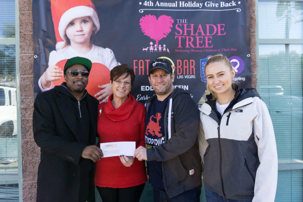 Eddie Griffin, Marlene Richter, Darin Feinstein, and Patricia Fenstein pose with a check for The Shade Tree Organization.