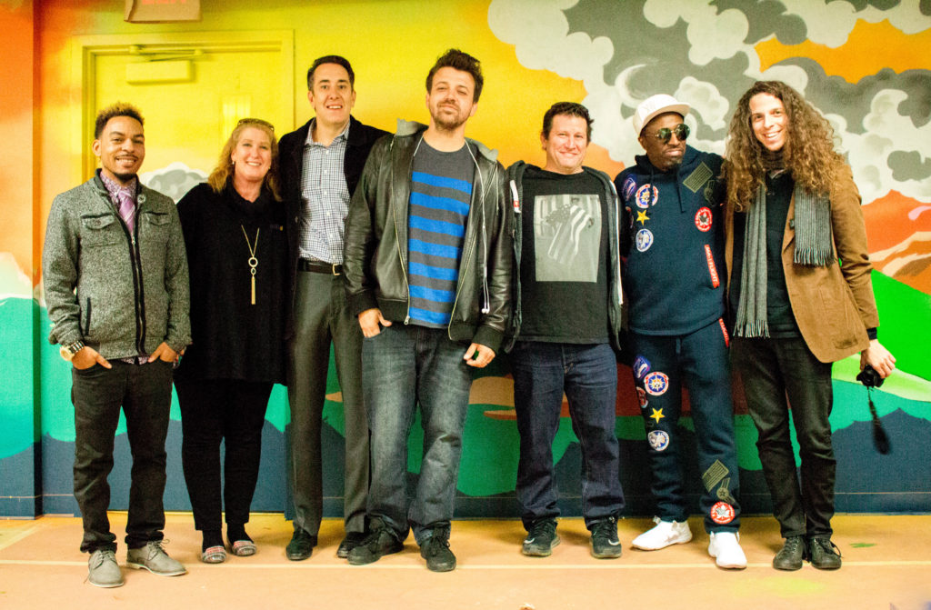 Darrell Weaver, Stacey Lockhart, Charlie Skinner, Brodie Knight Sawyer, Darin Feinstein, and Eddie Griffin pose for photo in front of the indoor mural at The Shade Tree.