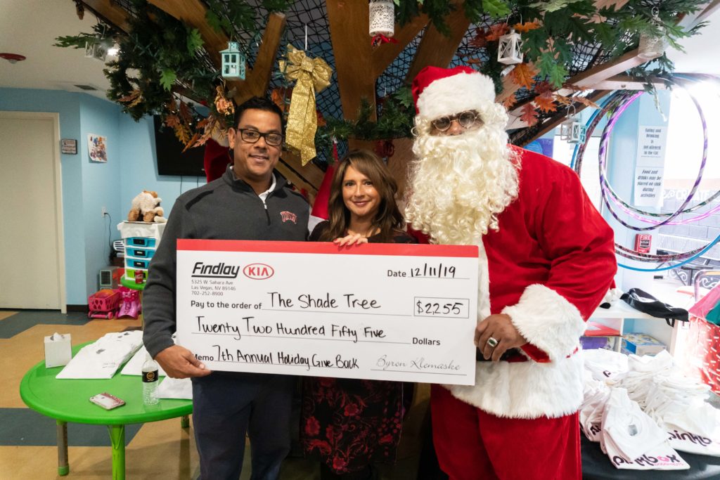 Findlay Kia and Santa Claus present check to Linda C. Perez of The Shade Tree.